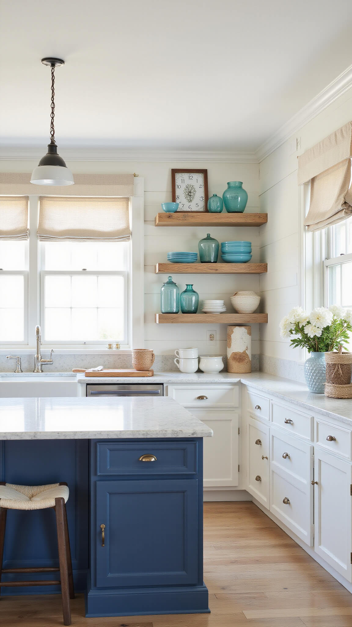 Coastal kitchen with alabaster shiplap walls, navy blue island, open beach-themed shelving, rope pendant lights, driftwood accents, and morning light filtering through linen curtains.
