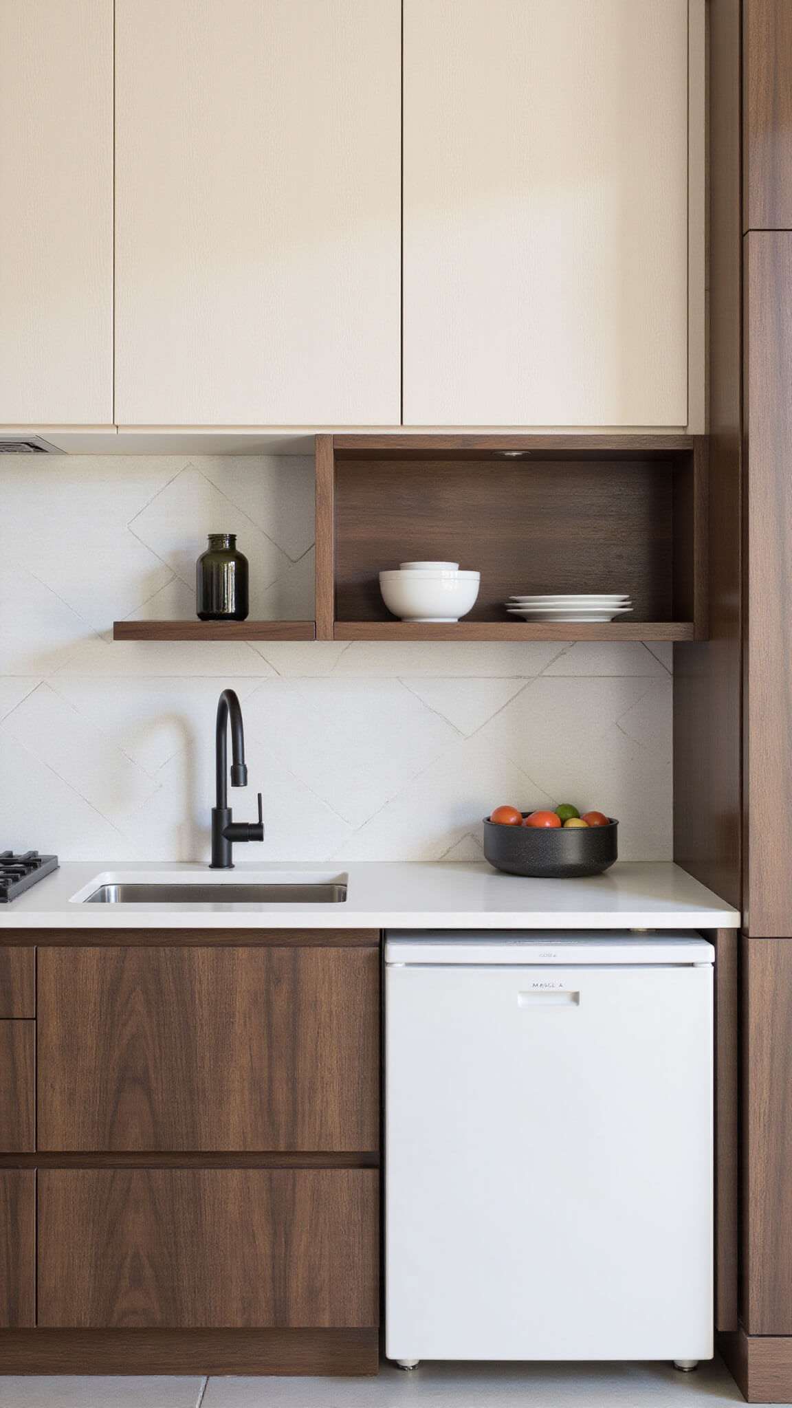 Contemporary two-toned kitchen with birch upper and walnut lower cabinets, white quartz countertops, geometric tile backsplash, and matte black hardware.